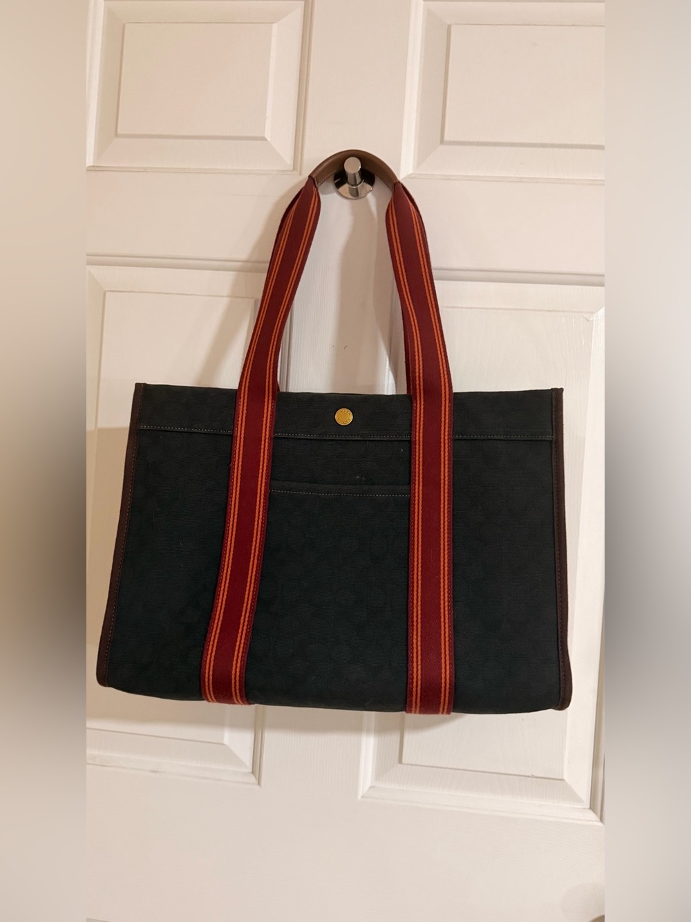 Coach Navy Spin Tote 42 Bag with Red Striped Handles.